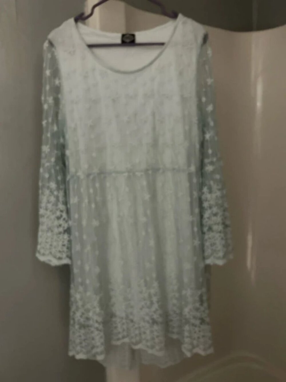 Light blue knee length dress with sheer overlay and sleeves